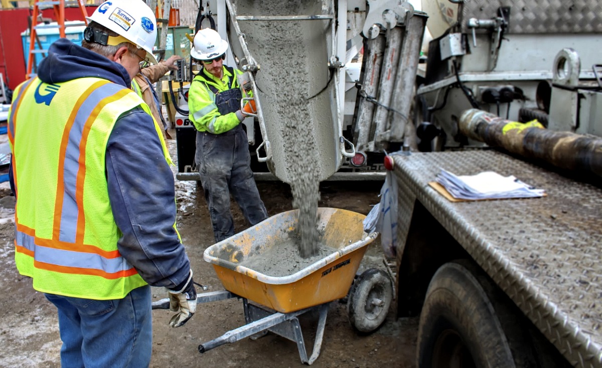 AOG Technician Calvin Hiebert prepares to pull test samples from a fresh concrete mixture.