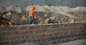 Alpha-Omega Geotech field inspector at retaining wall