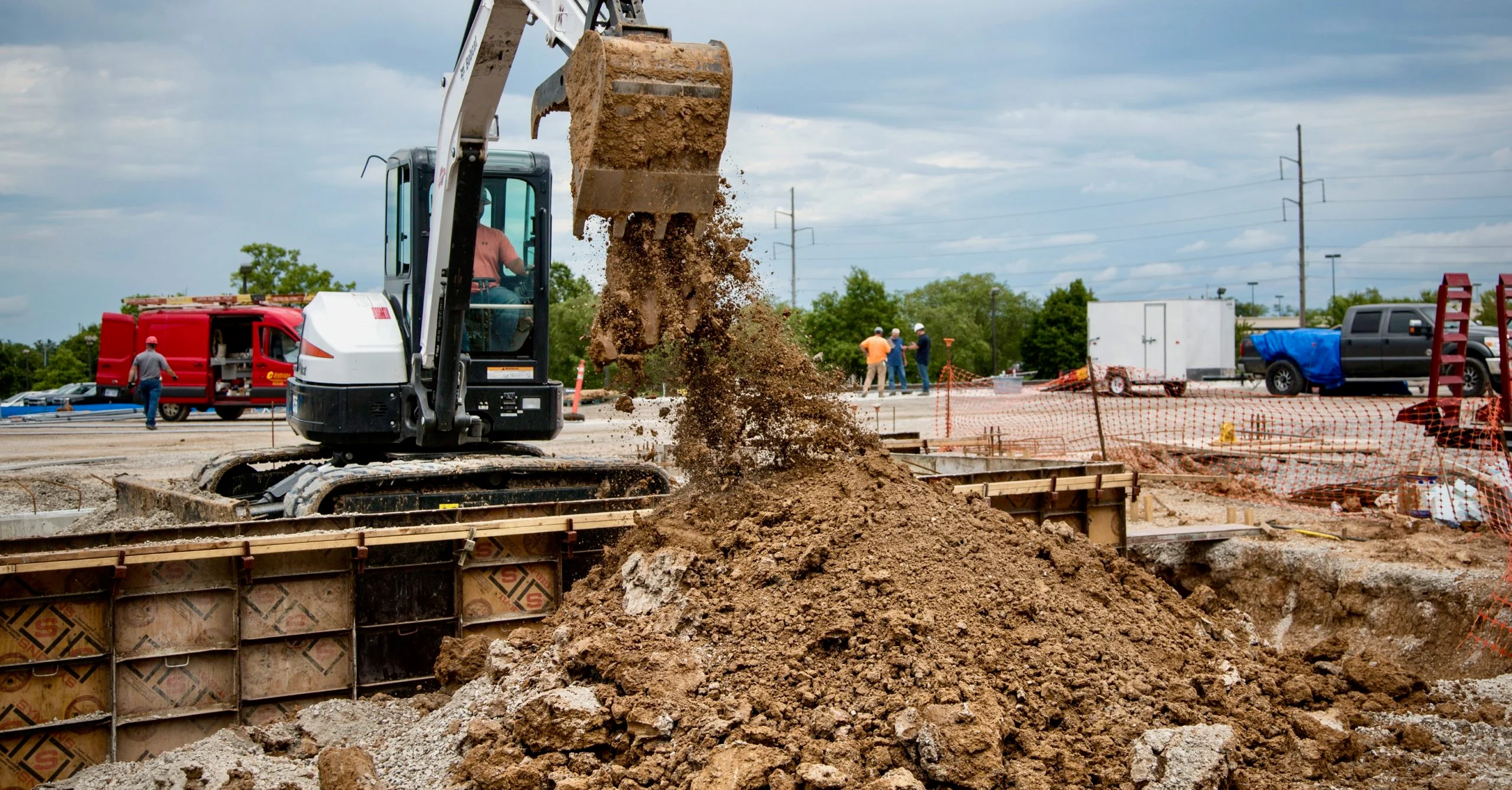Moving earth materials at a local construction site