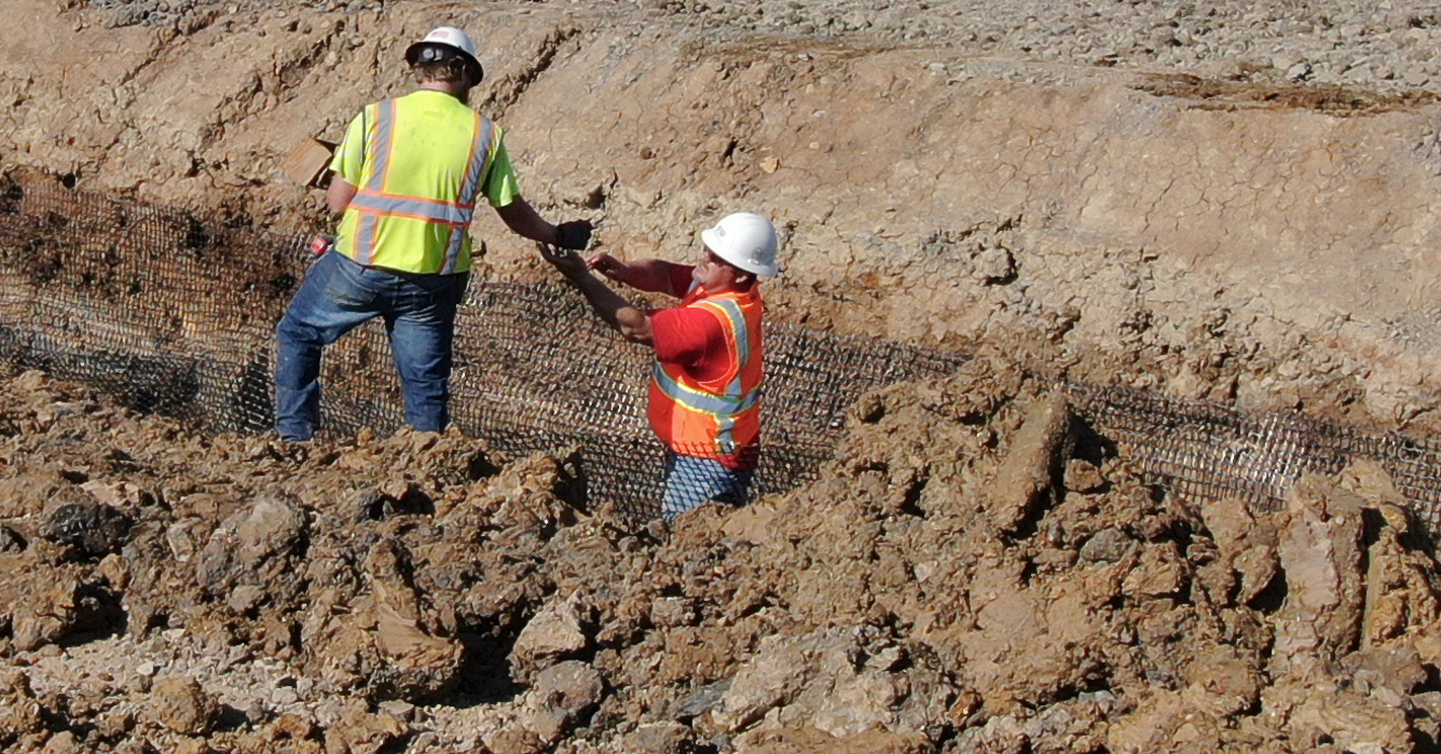two geotech field technicians collaborating at project site